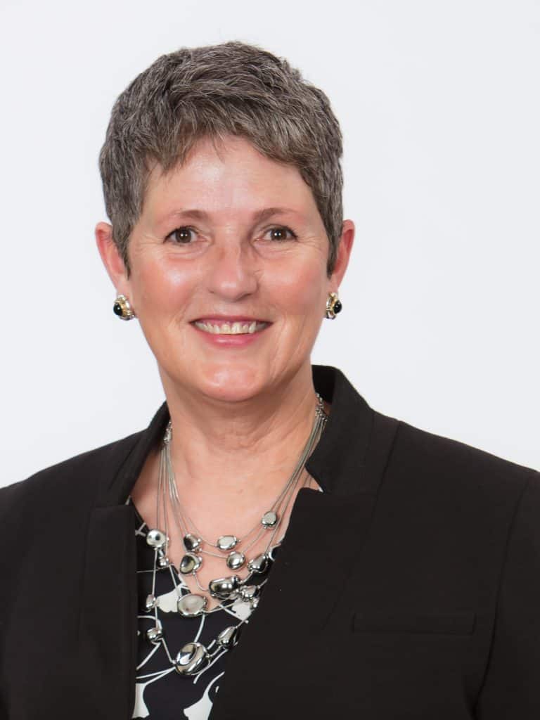 A professional woman with a short-cropped haircut.